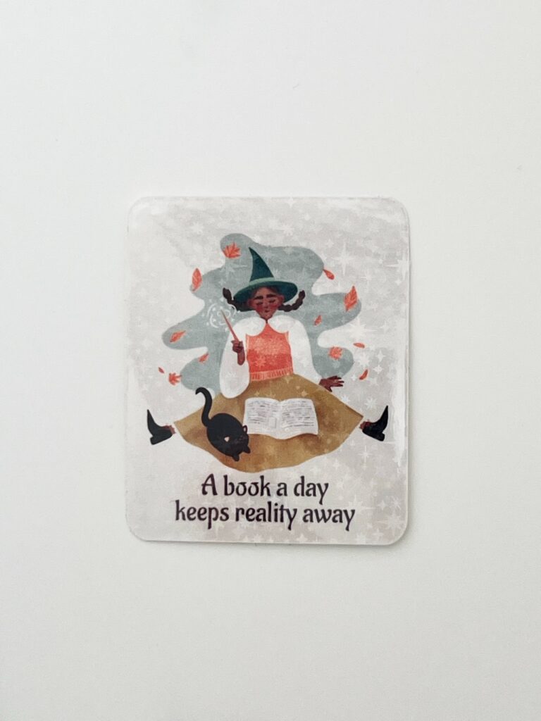 Vinyylitarra, jossa noita lukee kirjaa ja teksti A book a day keeps reality away